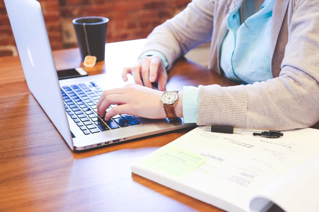 Person typing on a laptop in a modern office